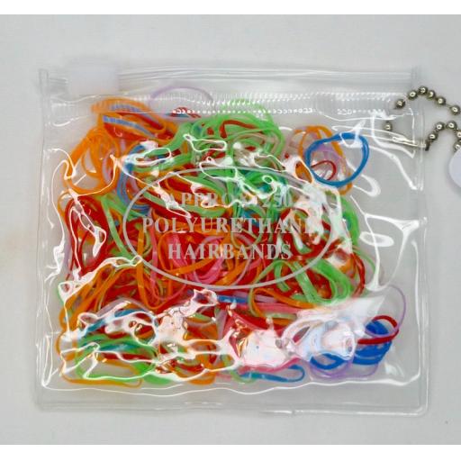 Transparent purse containing 250 Small polyurethane bands. Assorted Bright colou